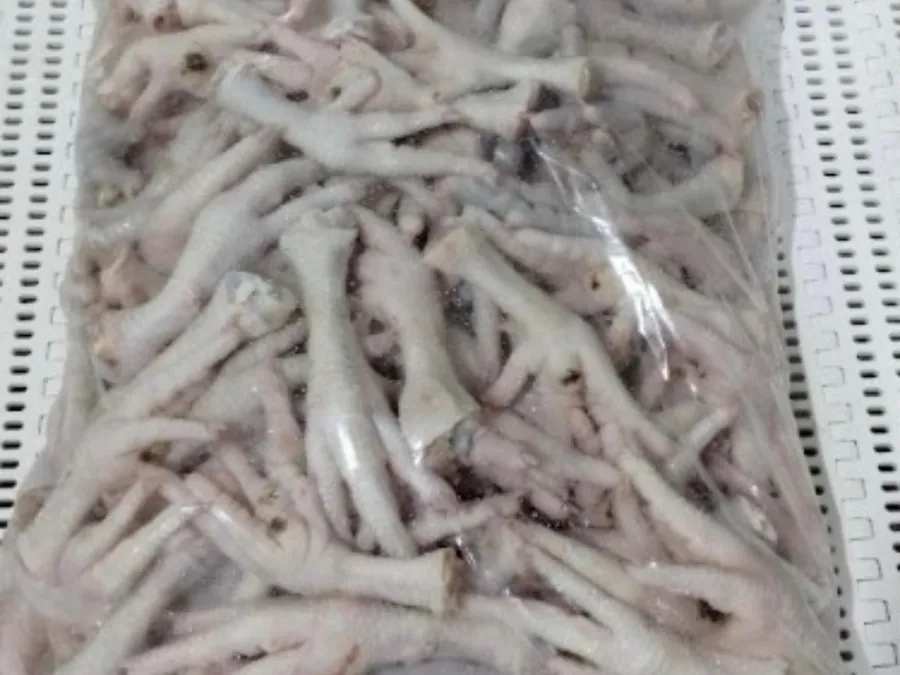 Clear plastic bag filled with raw chicken feet